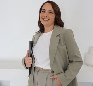 Milly Elisara, founder of Simply Organised, in a beige blazer, representing financial and home organ