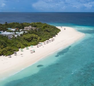 a beach with a white sand and blue sky