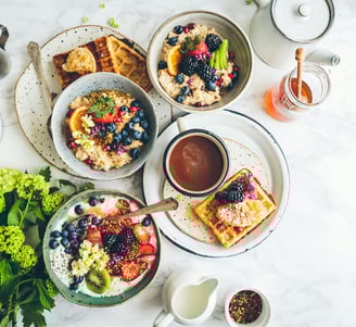 a table with plates of food and a cup of coffee