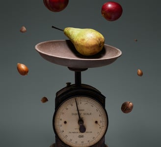 a pear on a scale scale scale with apples and nuts