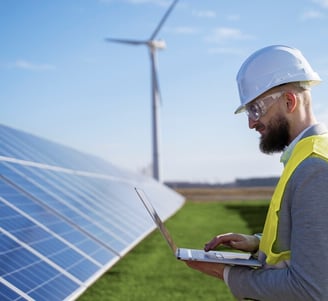 a man in a hard hat and a laptop computer