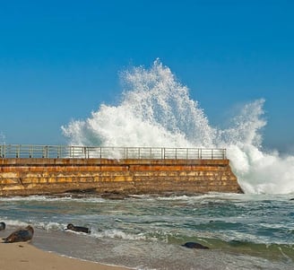 water splashing on seawall