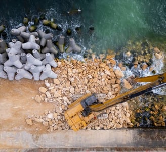 miami seawall waterfront with water and an excavator