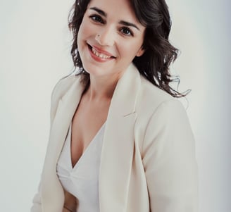 a woman in a white shirt and jeans sitting on a chair
