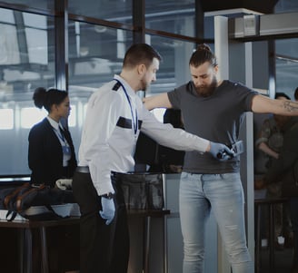 a man standing in front of a metal detector