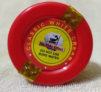 a red plastic water bottle with a red and yellow label on it