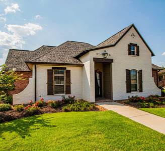 Photo of rancher style house basking in mid-day sunshine.