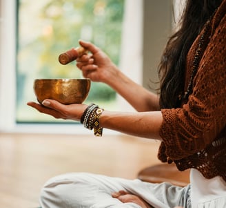 woman in brown knit sweater holding brown ceramic bowl