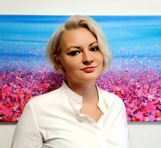 a woman in a white shirt and a painting of a flower