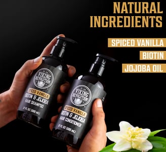 two hands holding two bottles of vanilla shampoo and conditioner