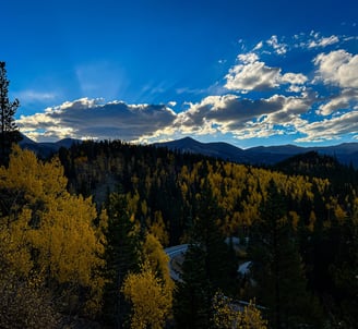 a mountain scene with a winding road and a winding road