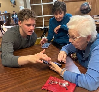students from Teens Who Tech help elderly individuals feel more comfortable with technology devices
