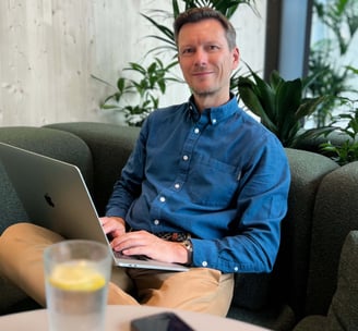 Andreas Frank, Interim CFO, working on a laptop in a relaxed office setting