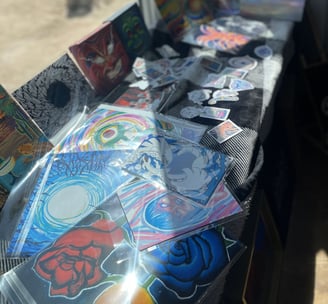 a table with a bunch of handmade art for sale!