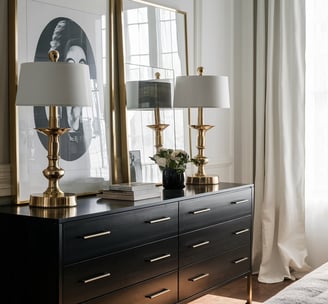 a dresser with a lamp and a lamp