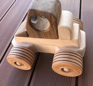 a wooden toy truck with a wooden toy car