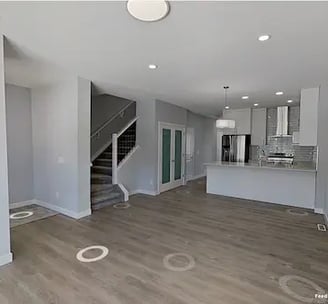 a living room with a staircase and a staircase