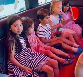 Kids on party bus on their way to Claw Store