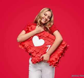 a woman holding a pinatable shaped pinatable