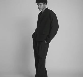 a man in a suit and tie is standing in a studio