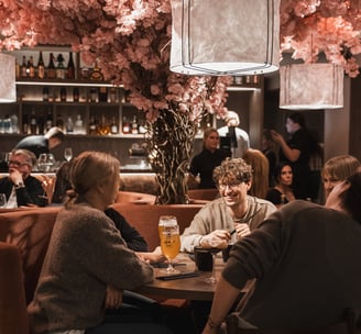 a group of people sitting at a table with drinks