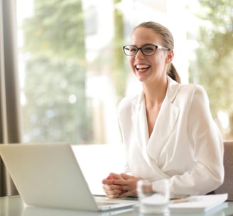 a woman in a robe is smiling and laughing