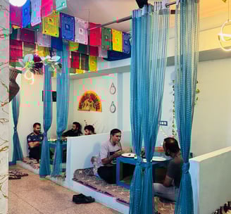 a group of people sitting at tables with colorful flags