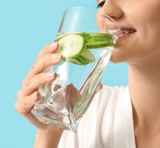 woman drinking cucumber water