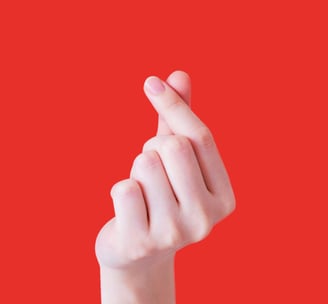 Hand forming a heart shape. Donate to Sixth Station Catholic Homeless Care