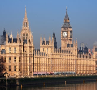 a large building with a clock tower in the background