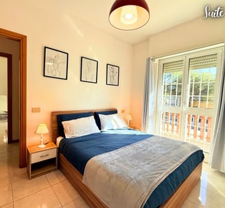 a bedroom with a bed and a balcony air conditioner