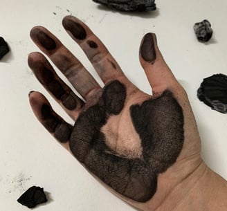 a person's hand painted with black Expressive Arts therapy Ukraine