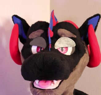 A dragon head made by Teto Creations featuring large curly horns, expressive moving eyelids and silicone teeth