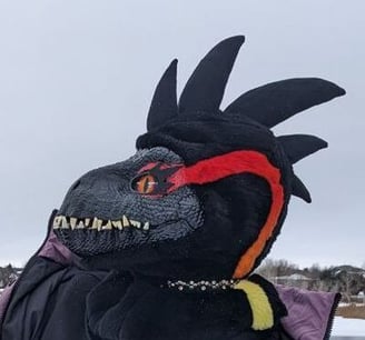 A incorporator fursuit Dino mask made by Teto Creations Featuriong a line of horns, 3d printed eyes and a painted gradient