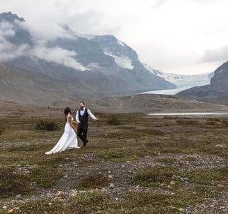 a bride and groom walking through the icefeilds in Banff