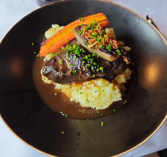 Beef main course on dark plate