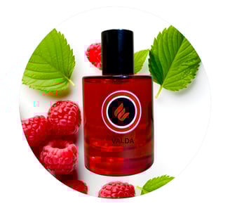 a bottle of valadaa perfume with raspberries and raspberries