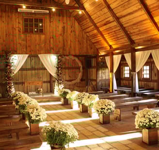 a barn decorated in off whites for a wedding