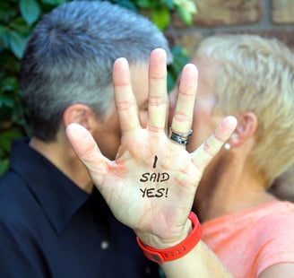 a middle aged couple kissing during their commitment ceremony