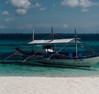 a boat on the beach with a boat in the water