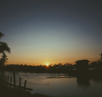 A small hut by the water body under the sunset, Kadamakkudy, Kerala, India