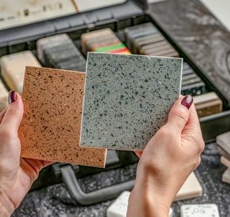 a woman holding a piece of granited stone