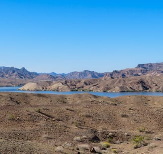 Colorado river winding through the desert in the distance with desert and mountains