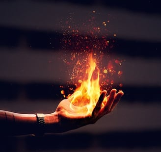 Young person holding fire in their hand.