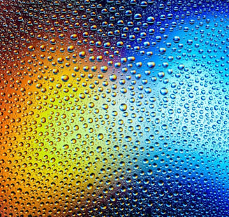 Yellow and blue lights behind rainy glass.
