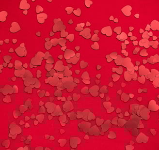 Numerous red hearts in a red background.