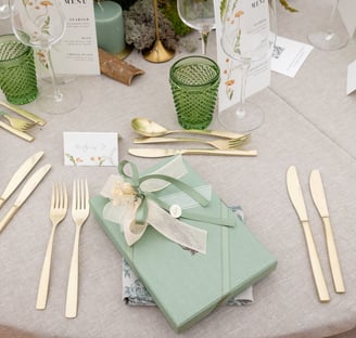 a table setting with a gift wrapped in a gift box