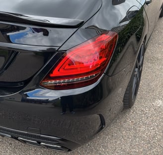 a black car parked in a parking lot
