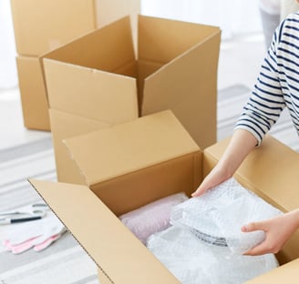 Careful packing of dishes with bubble wrap for stress-free moving and setup.