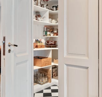 Custom-organized pantry with labeled boxes and glass storage for stress-free living.